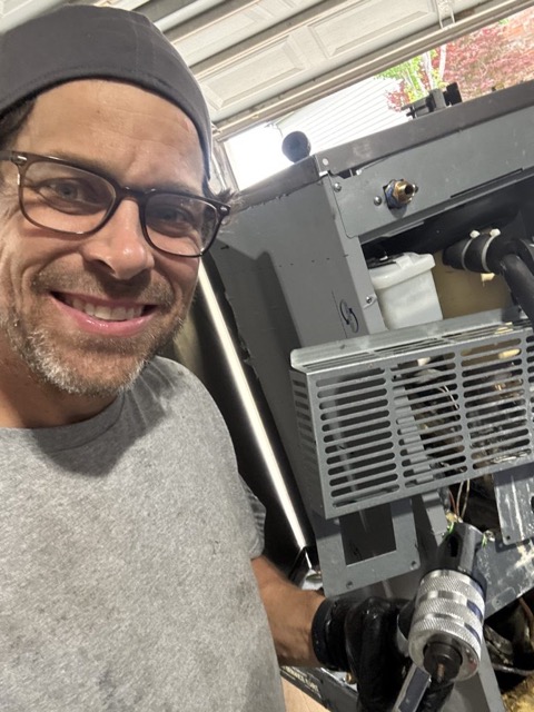 Smiling man servicing an ice machine